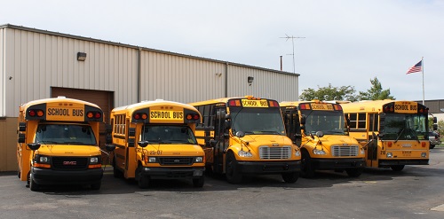 Five buses in the ServiCar bus fleet, holding a variety of passengers with adaptive equipment for special needs transporation.